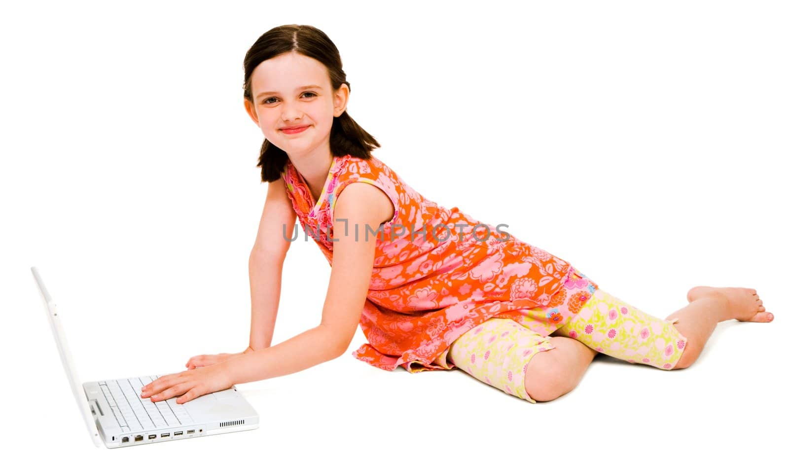 Portrait of a girl using a laptop and posing isolated over white