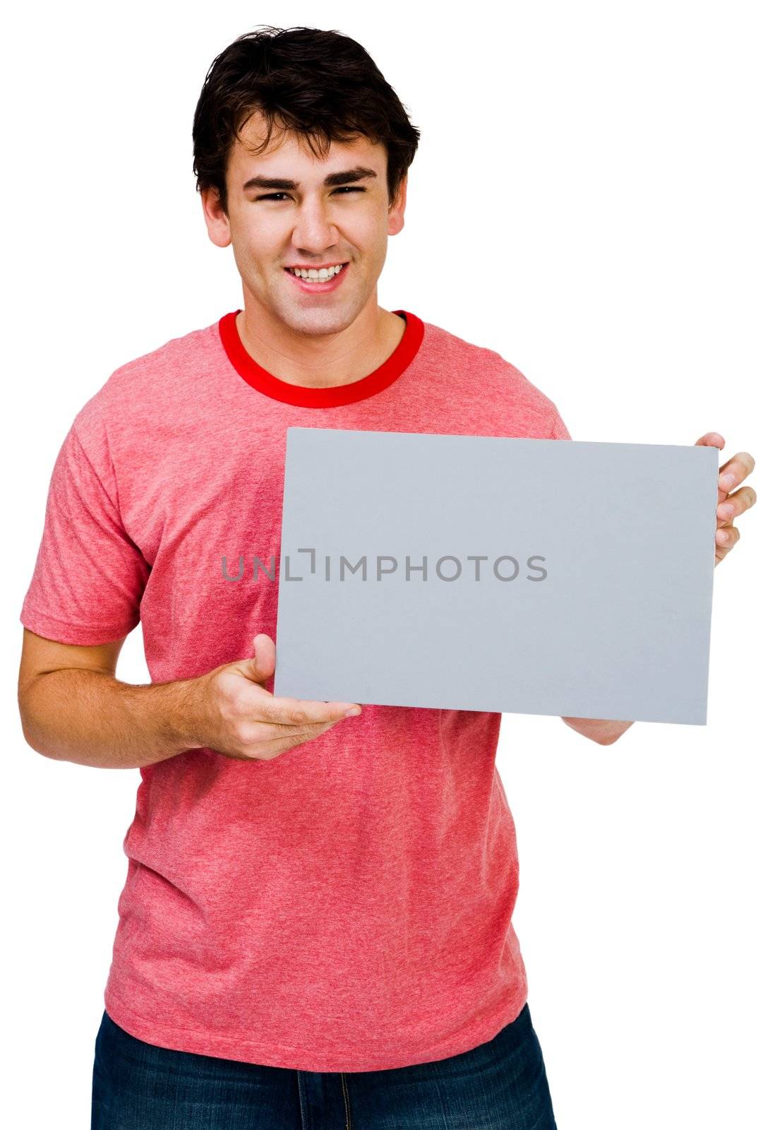 Handsome man showing a placard and smiling isolated over white
