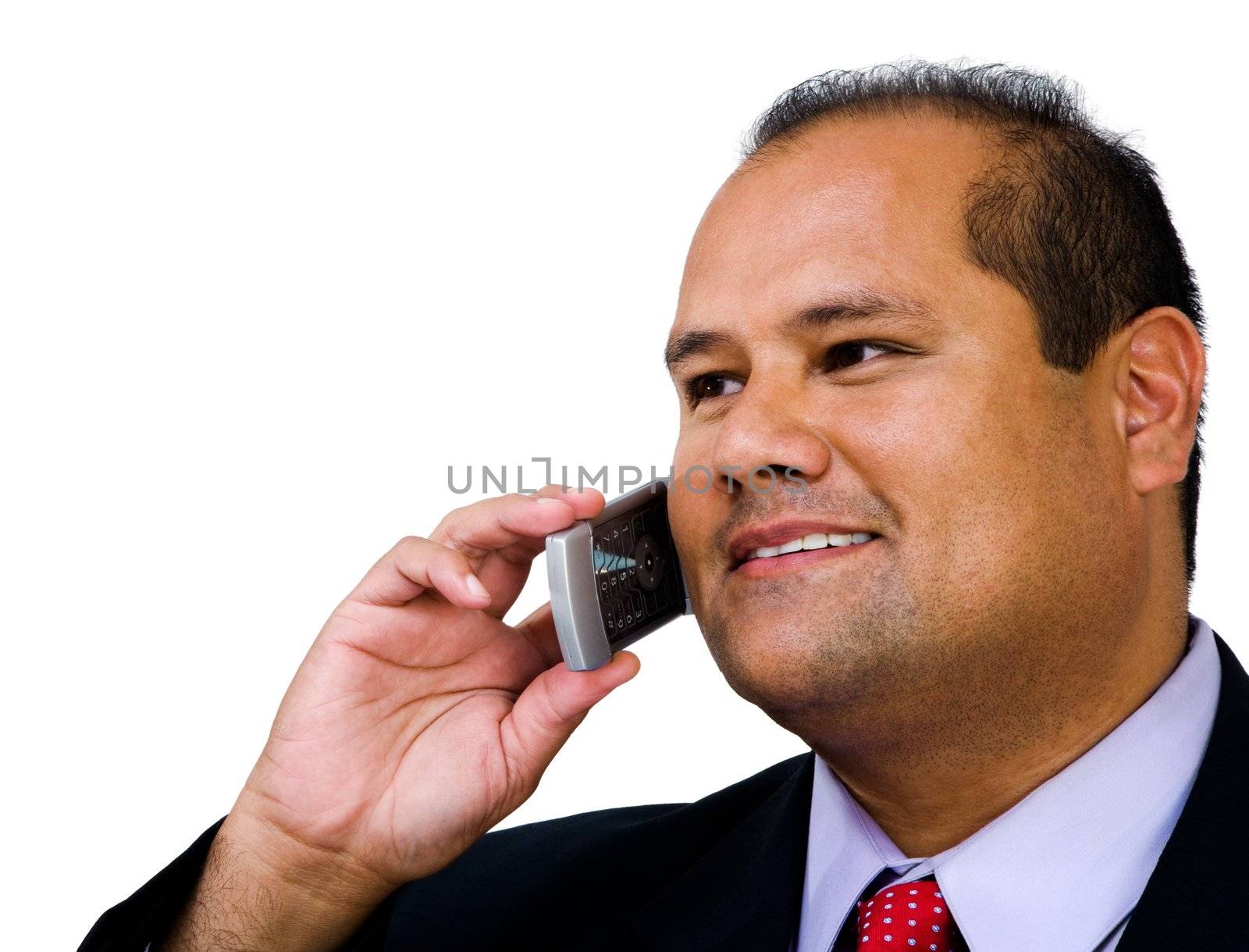 Businessman talking on a mobile phone and smiling isolated over white