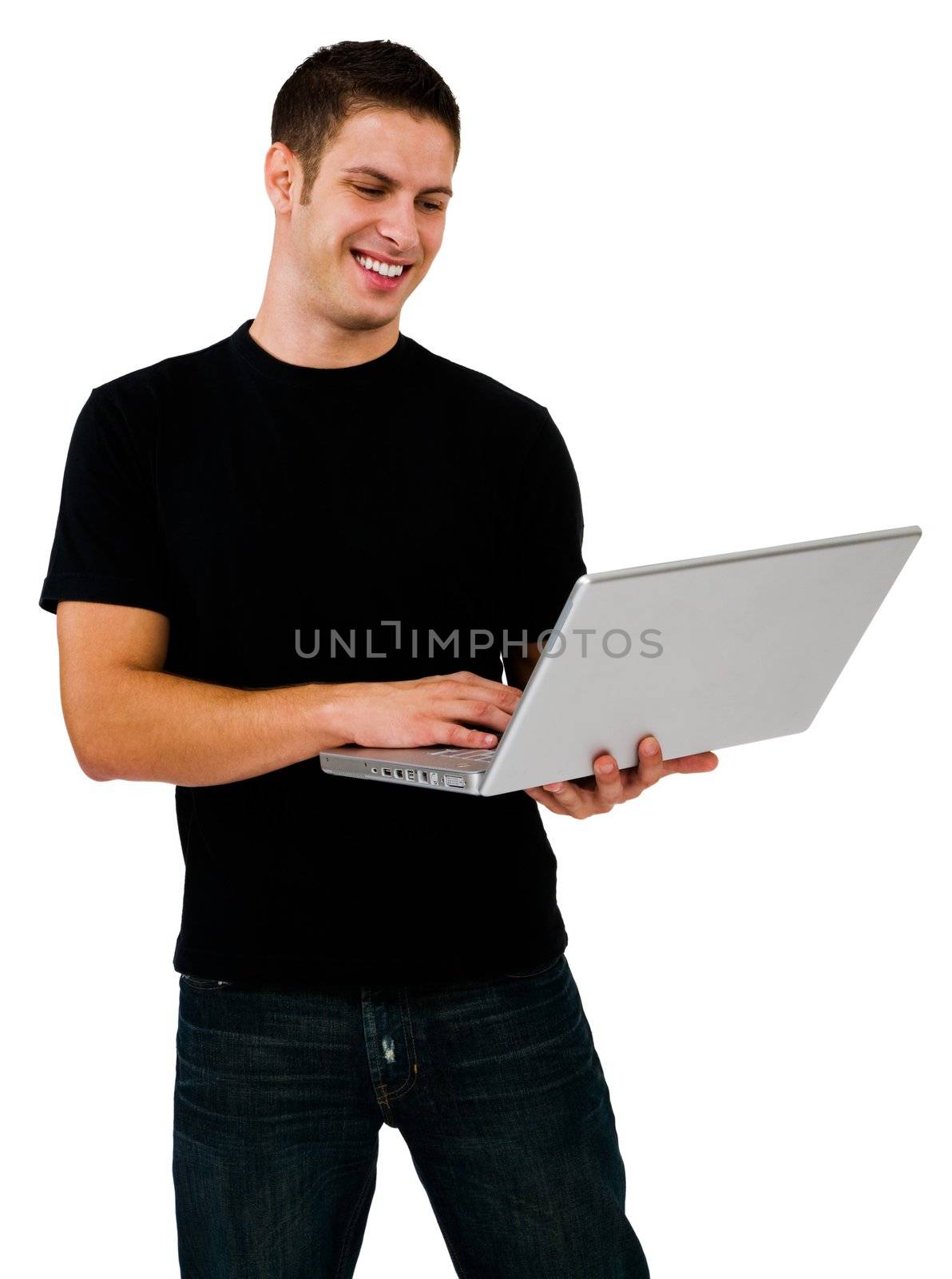Smiling man using a laptop and posing isolated over white