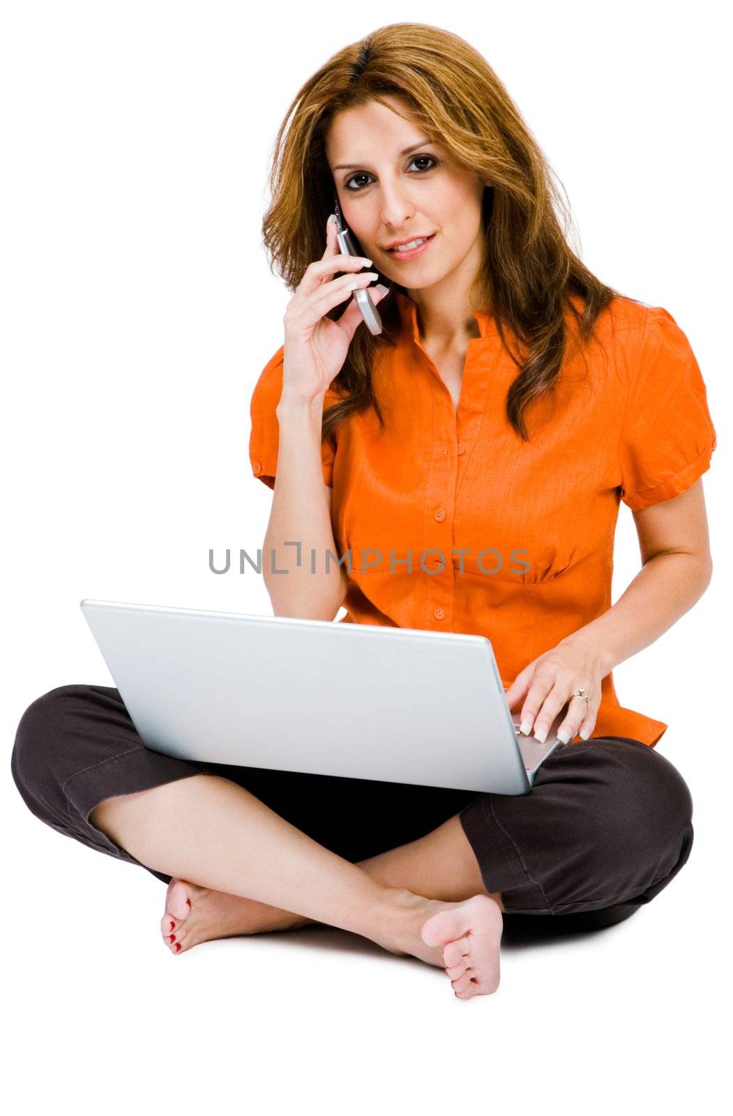 Happy woman using a laptop and a mobile isolated over white