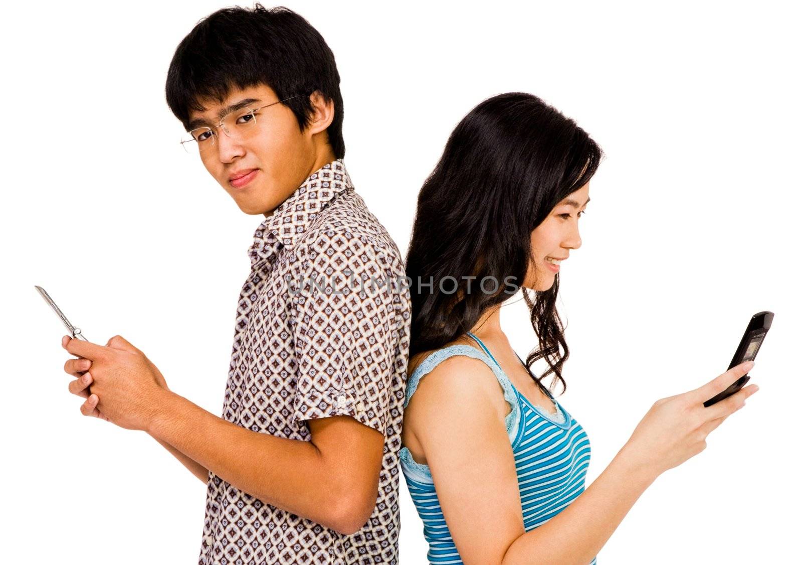 Confident couple text messaging on mobile phones isolated over white