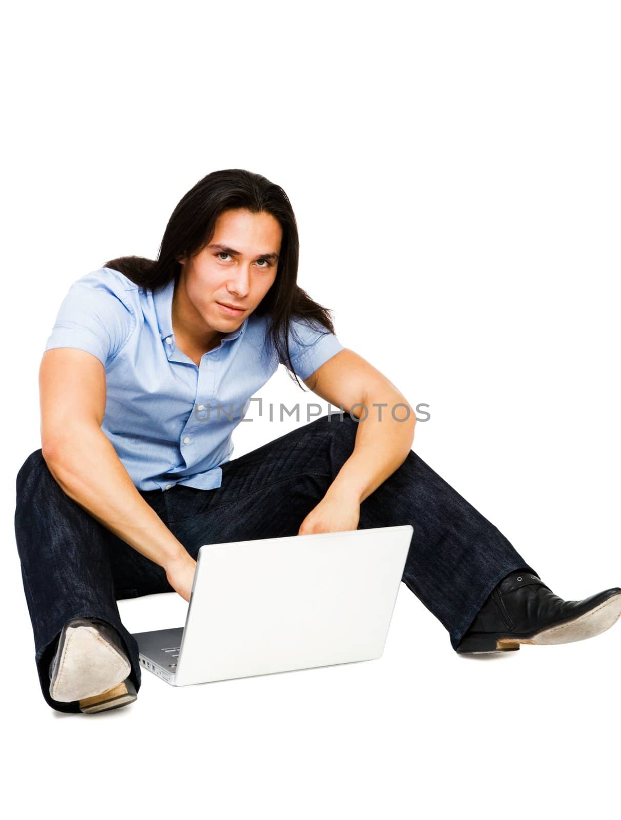 Young man using a laptop isolated over white