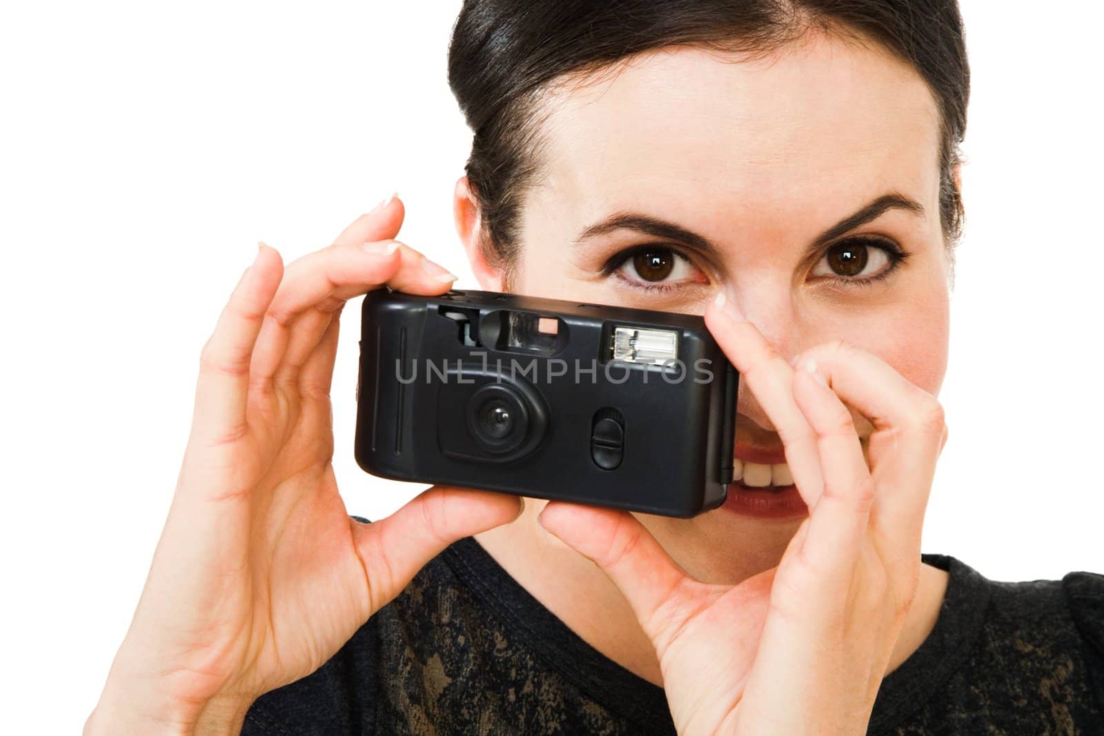 Caucasian woman photographing with a camera and smiling isolated over white