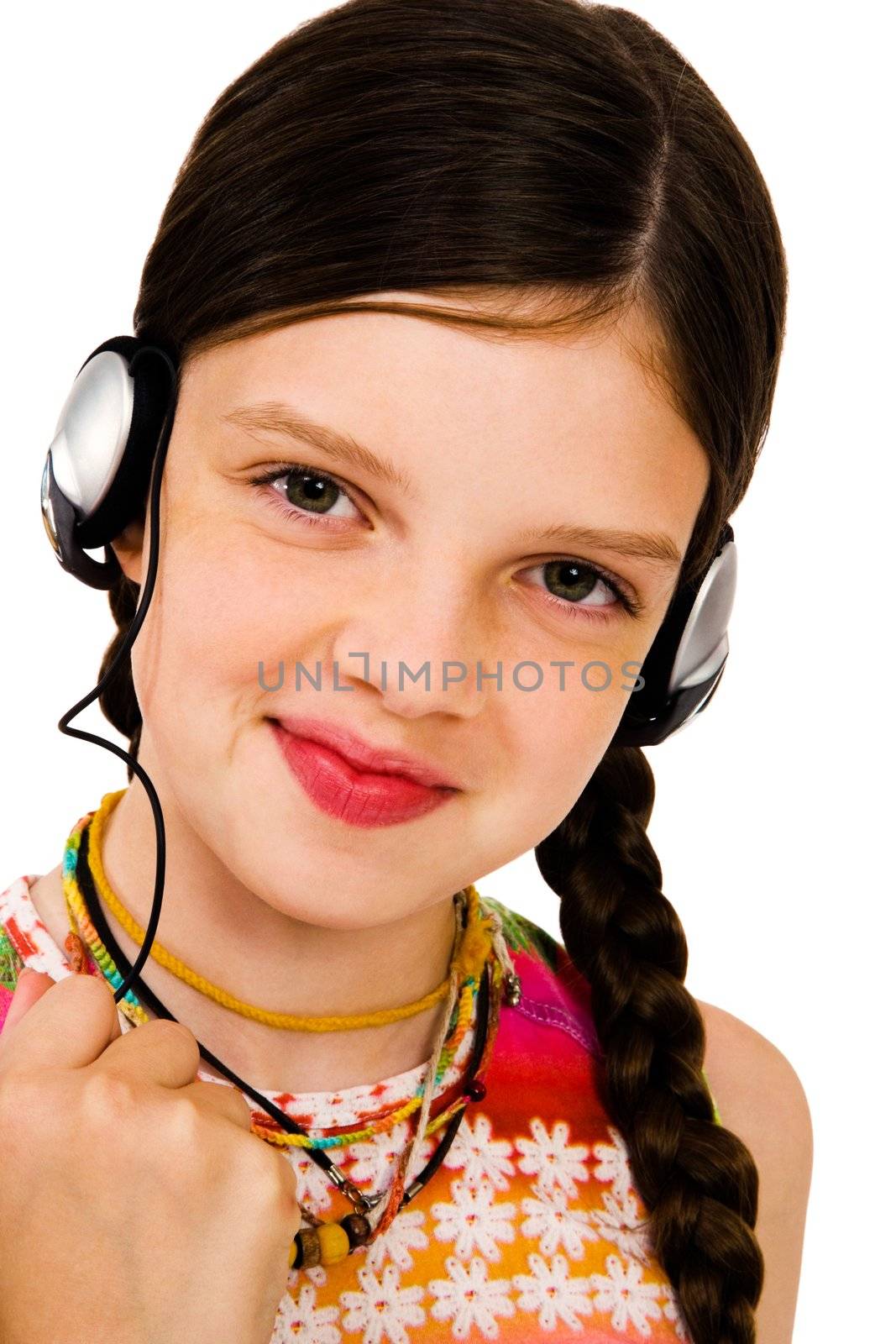 Portrait of a girl listening to music on headphones isolated over white