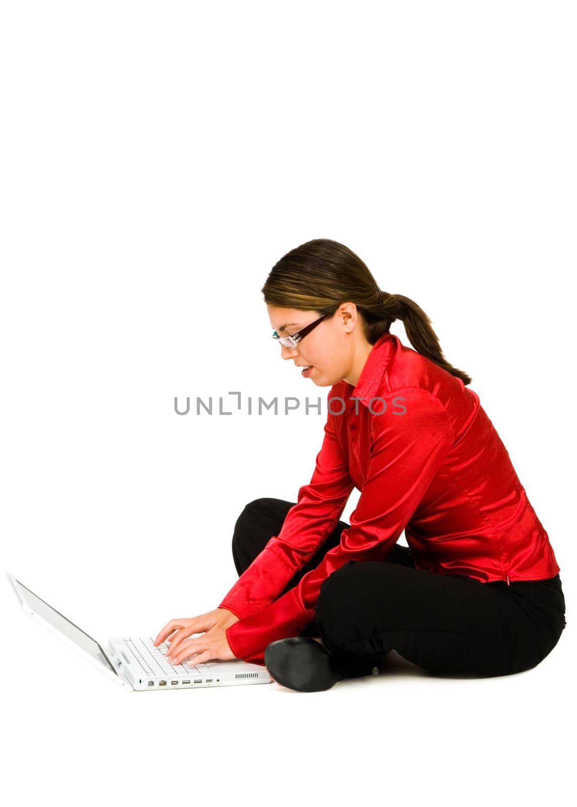 Mid adult woman using a laptop isolated over white