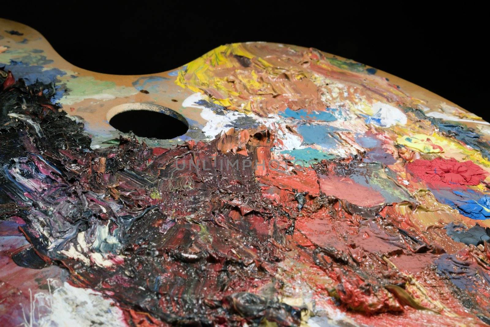 detail of a used wooden palette covered with paint in black back