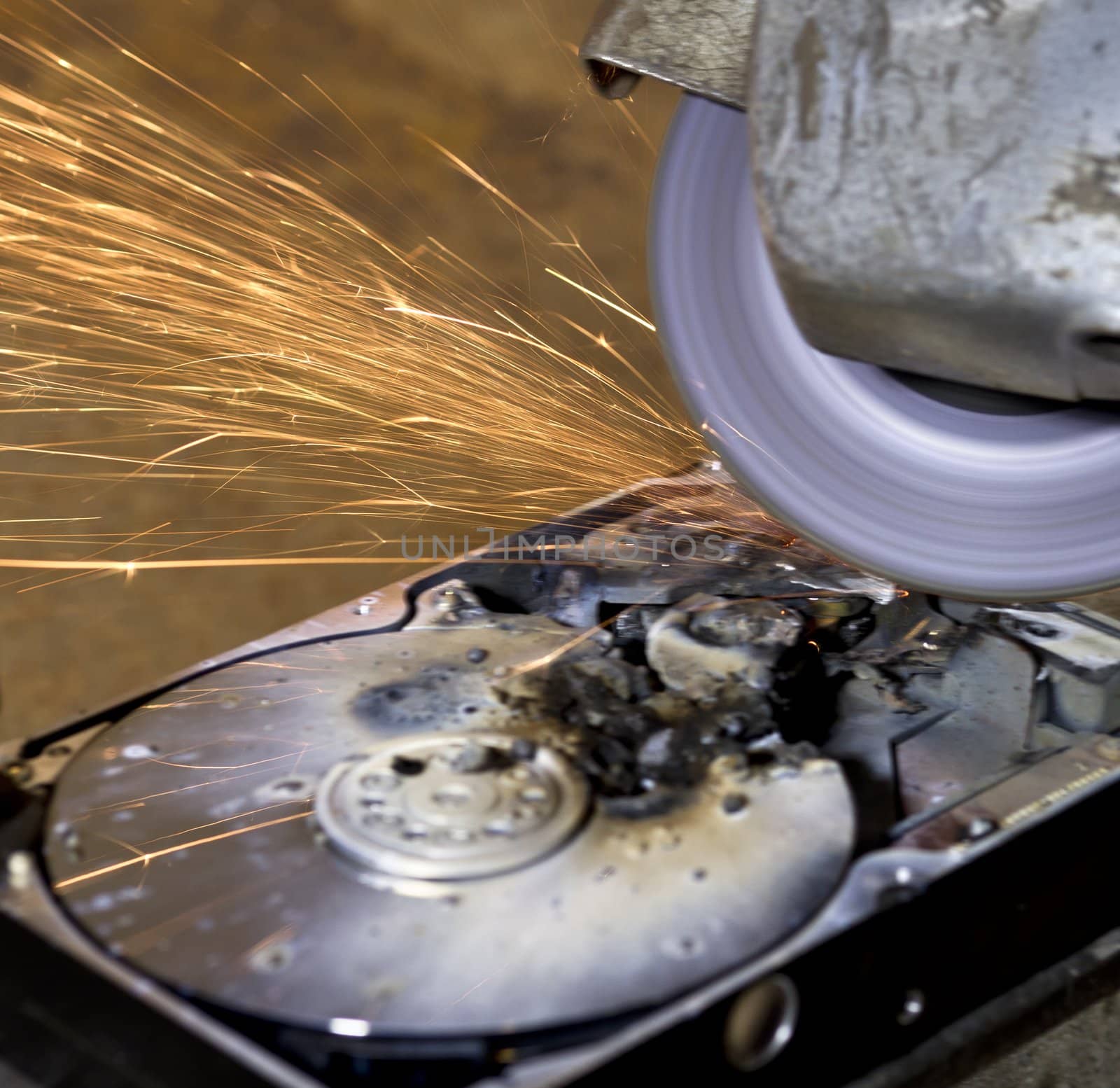 destructed, burned  open hard disk with circular saw