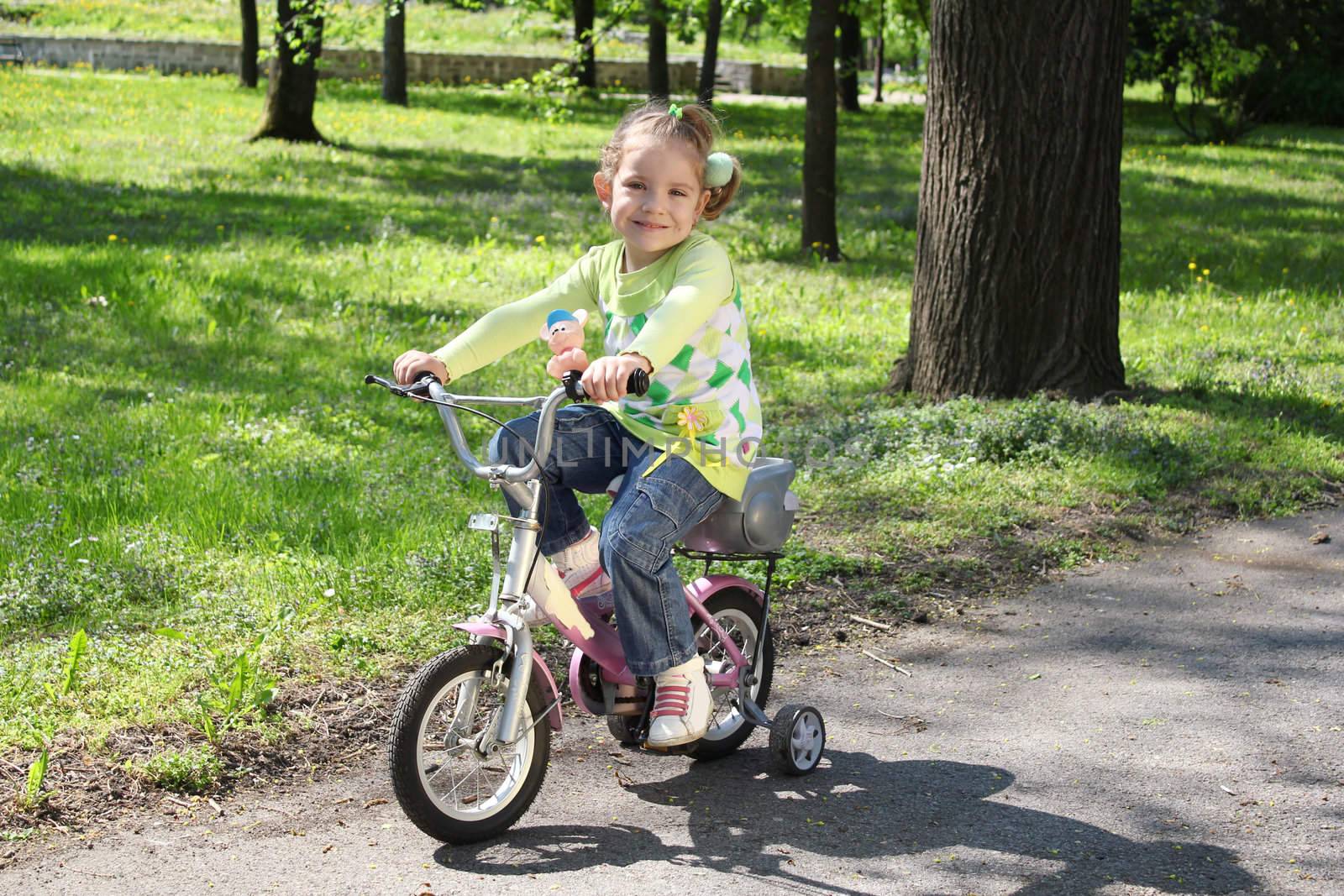 young girl riding bicycle in park