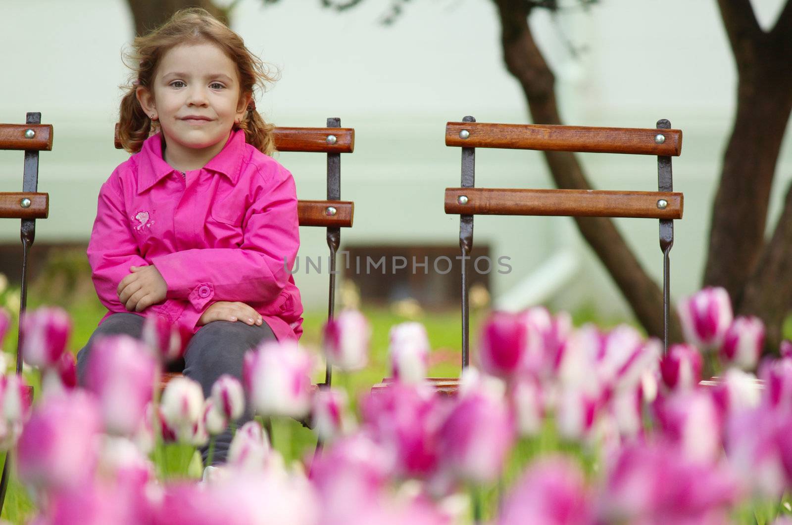young girl sitting in the park by goce