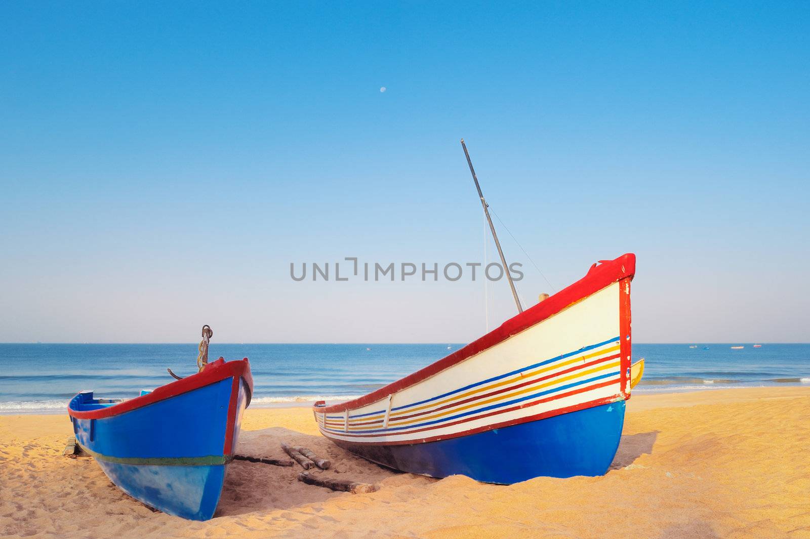 Two sailing boats on the sandy beach