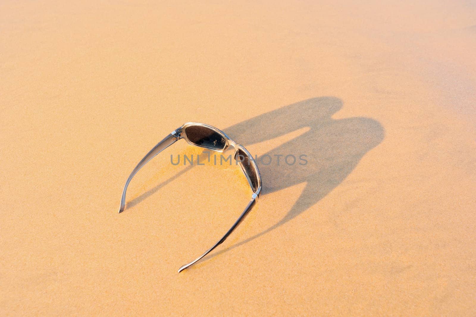 Sun glasses on the sandy sea shore