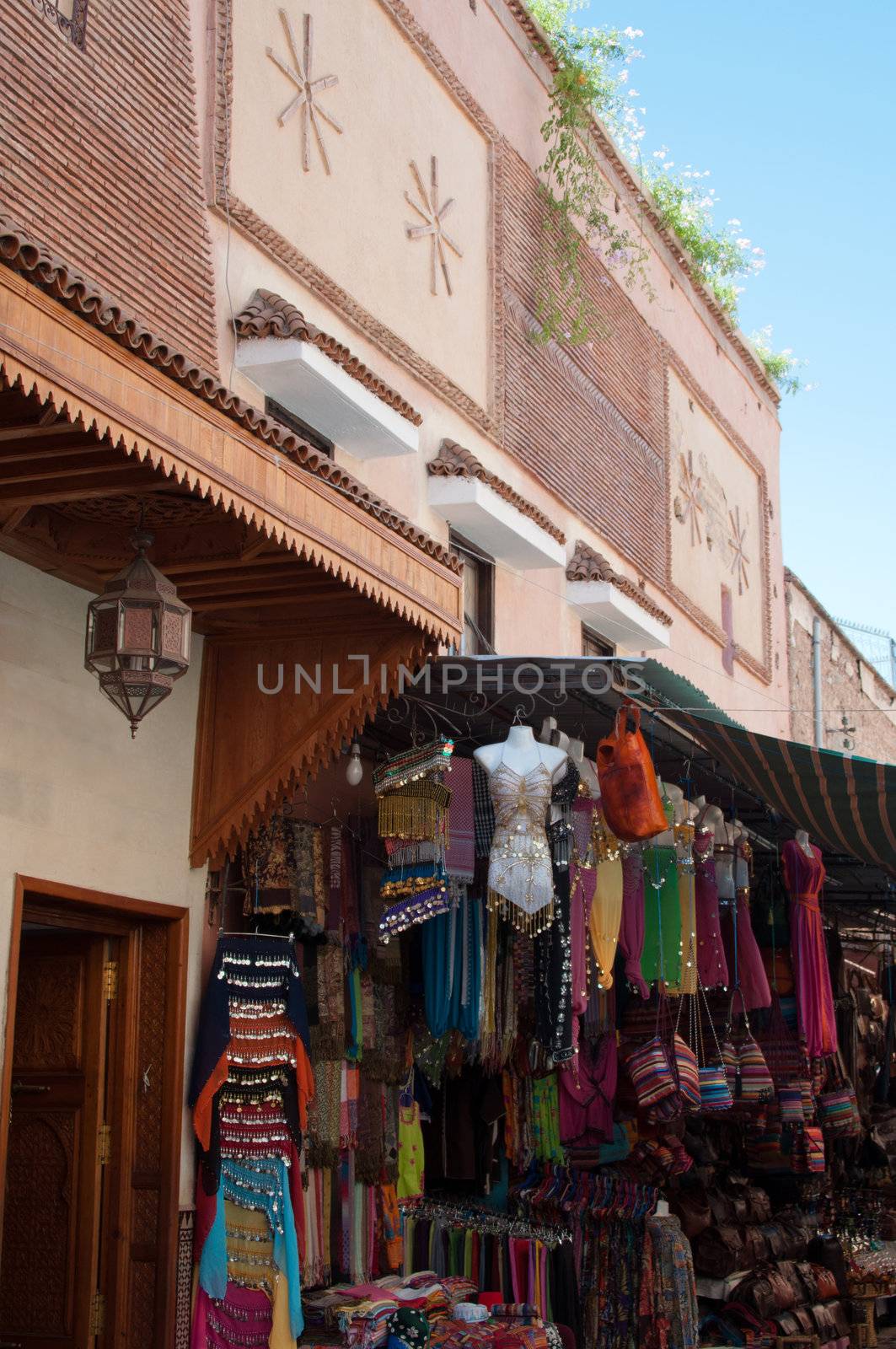 Clothes and leather bag for sale in the souk of Marrakesh Morocco