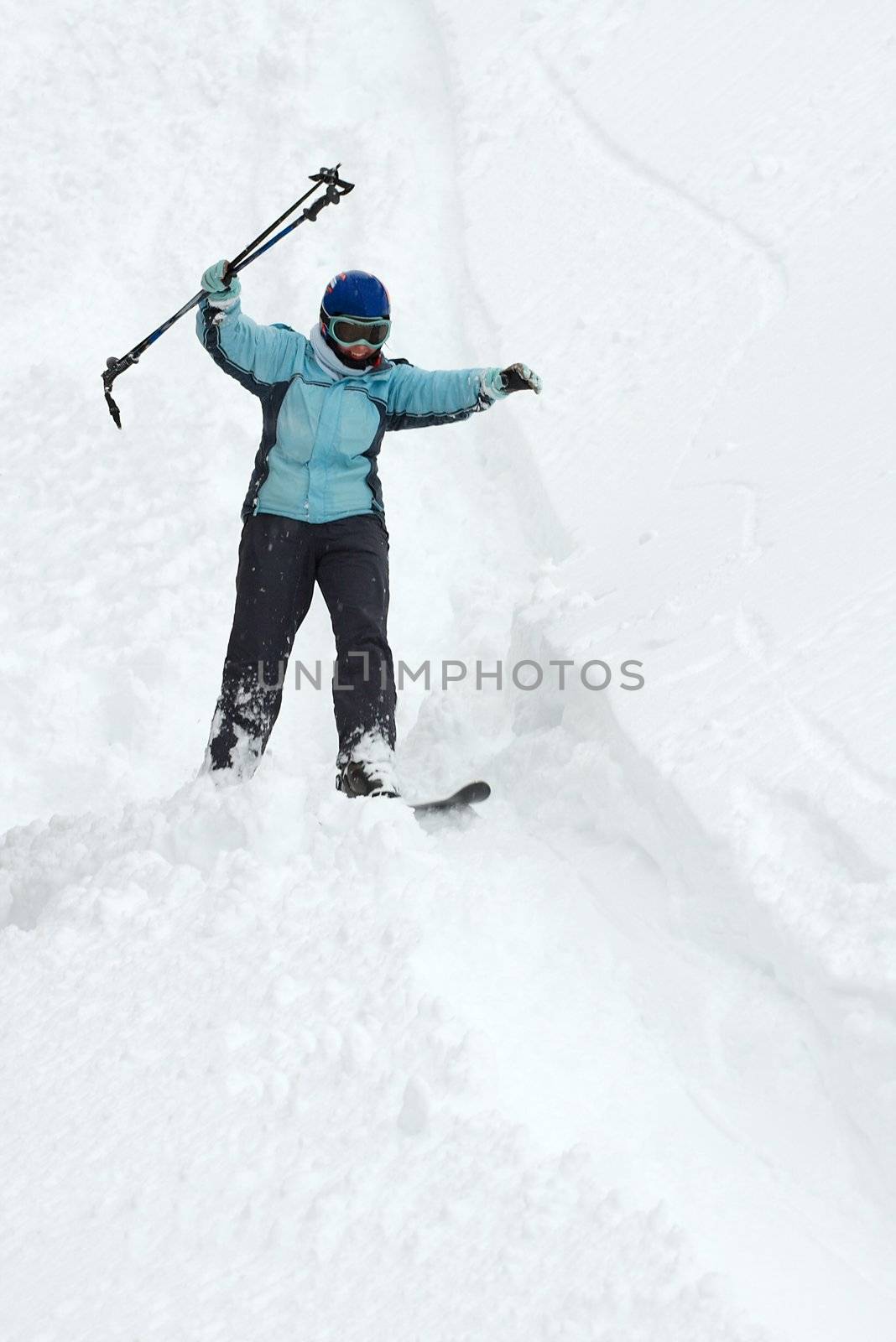 Skier coming down on an off-piste slope with fresh snow