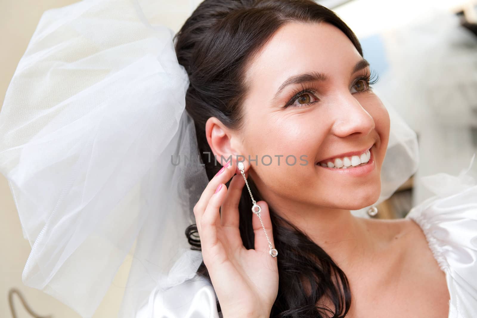 happy bride touching her ear-ring