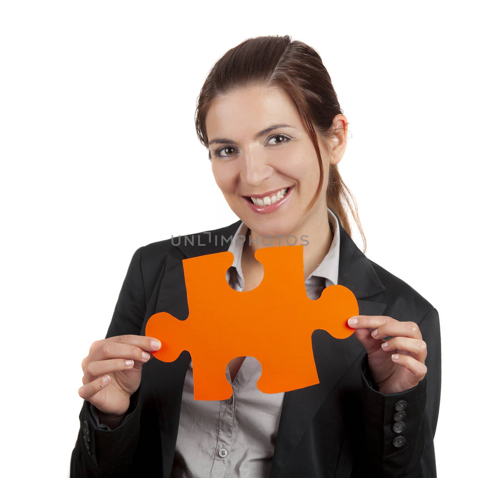 Business woman holding a big puzzle piece, isolated on white