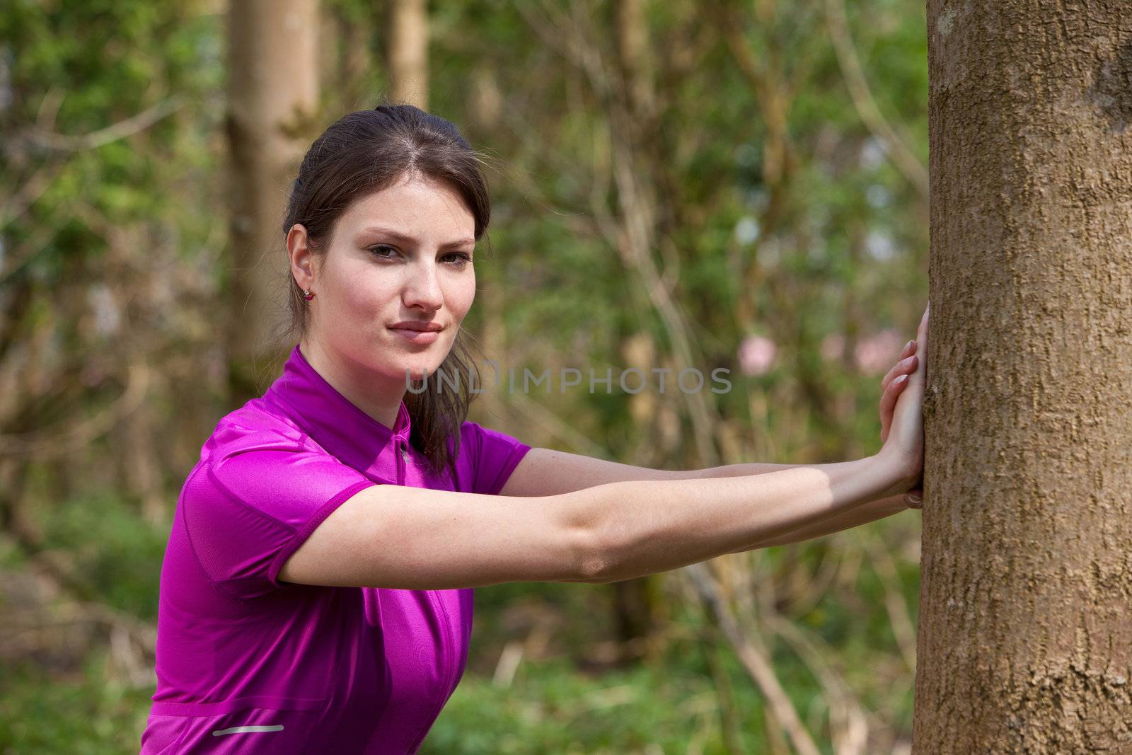 Woman stretching outdoors by Fotosmurf