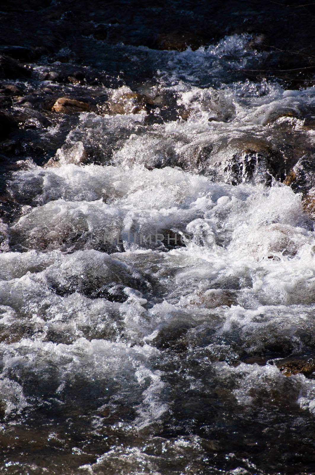 Mountain stream with falls from Hintertux Glacier in Zillertal, Austria