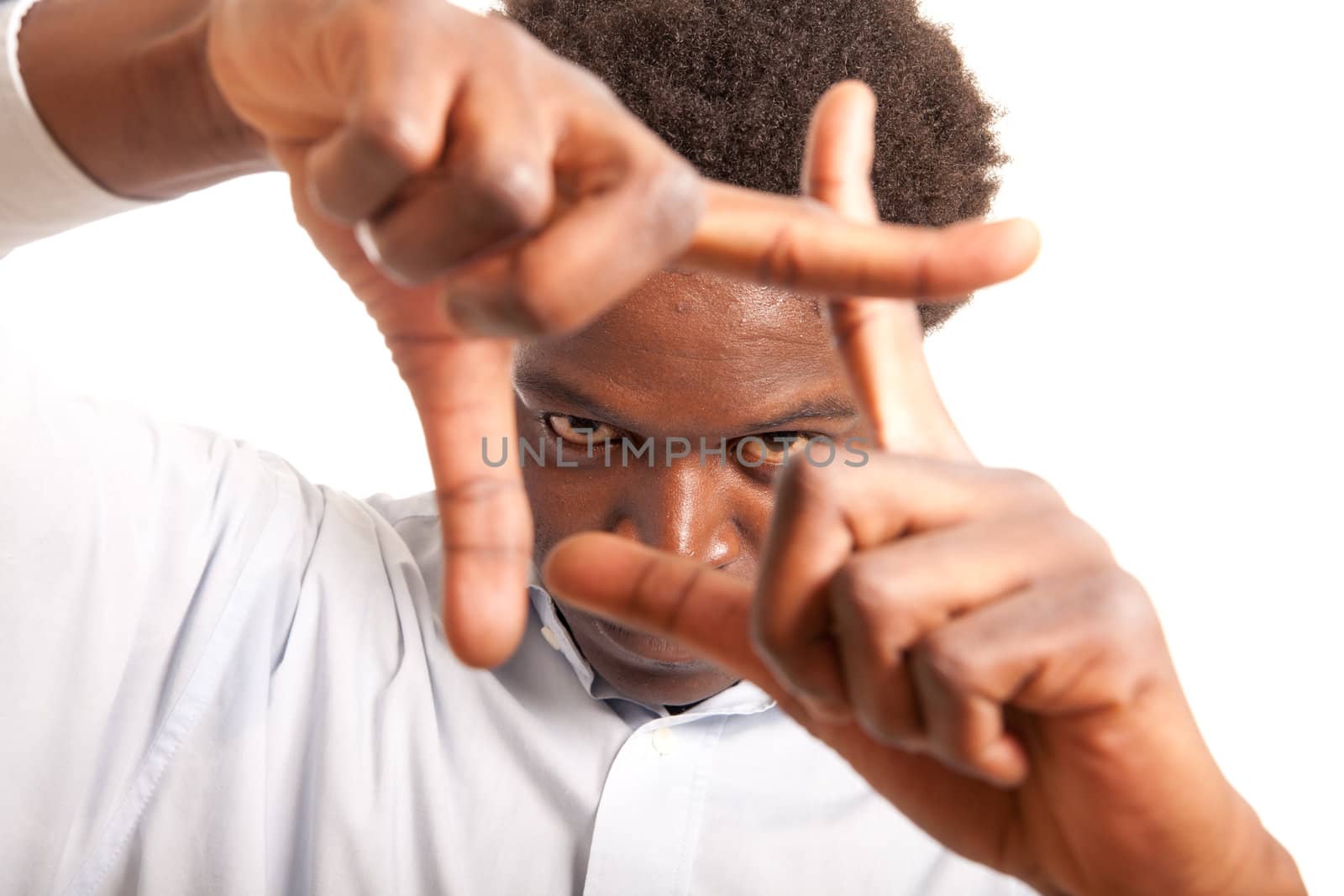 a young black man framing his face with his hands