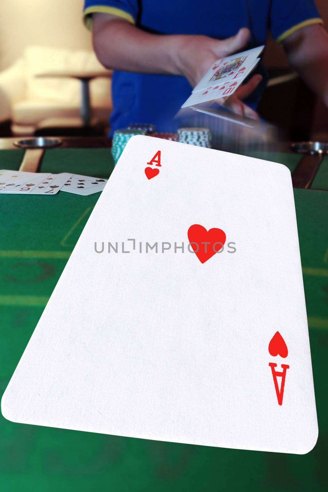 poker player throwing in cards with the ace of hearts in the foreground