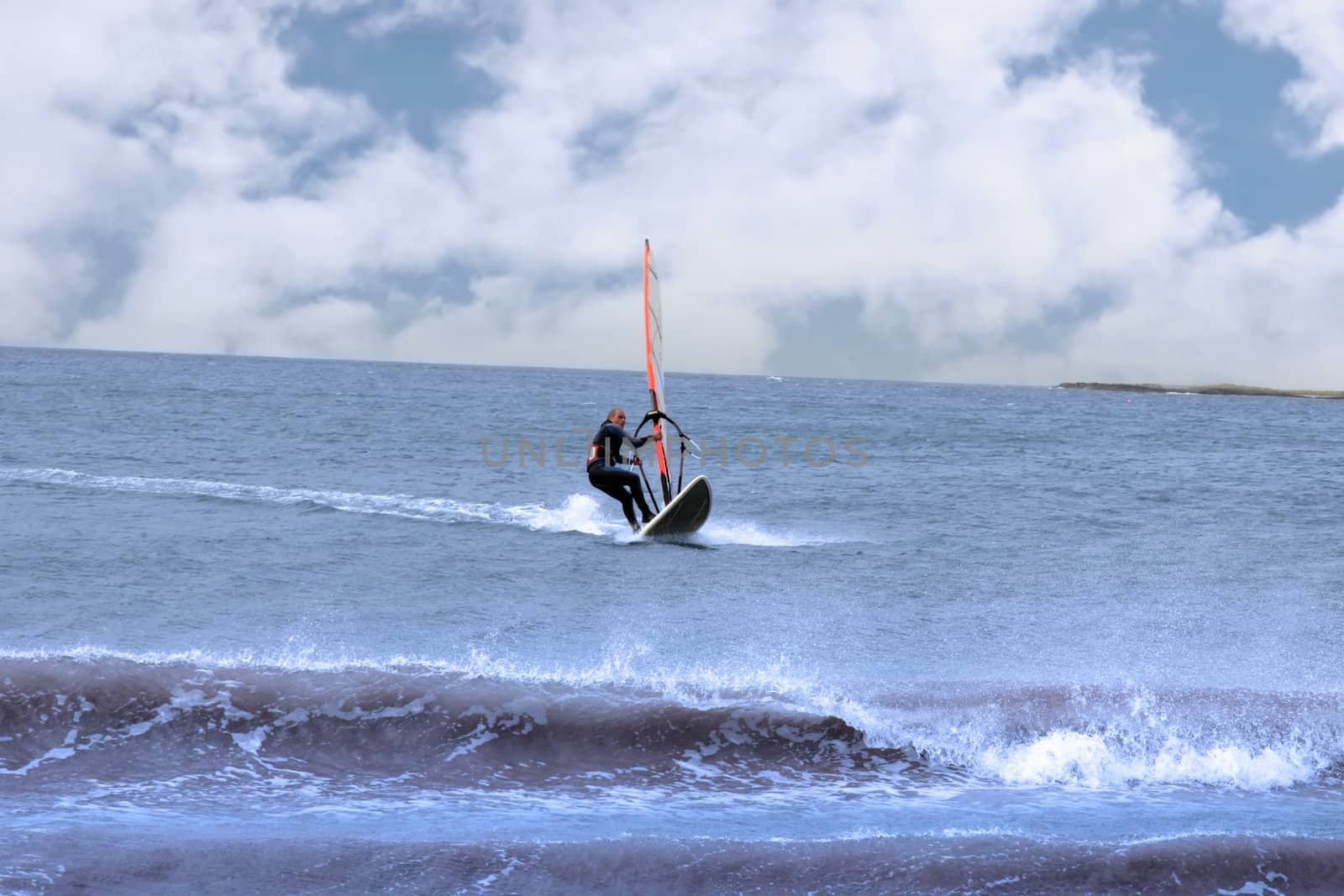 surfer windsurfing in a storm by morrbyte
