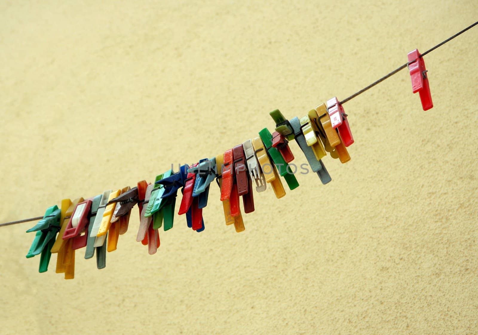 Row of old colored clothes pins. Lisbon, Portugal