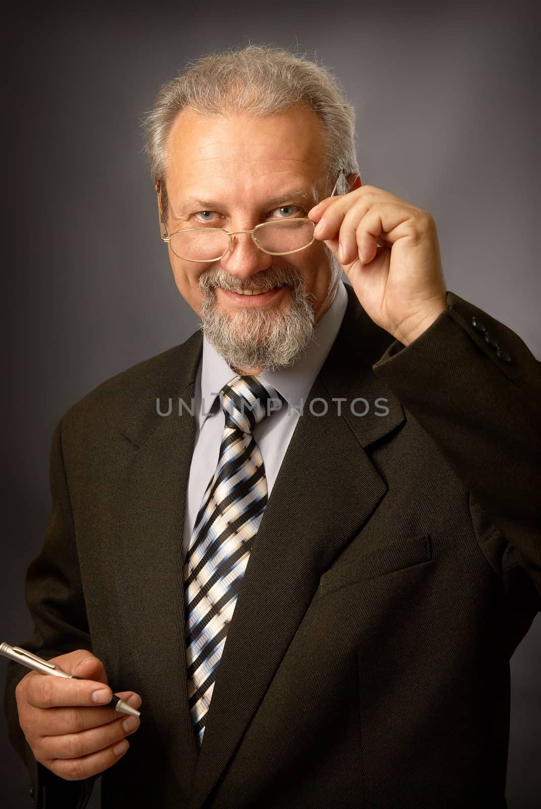 Medicine specialist (psychologist, teacher or doctor) on black background with glasses and pen in his hand