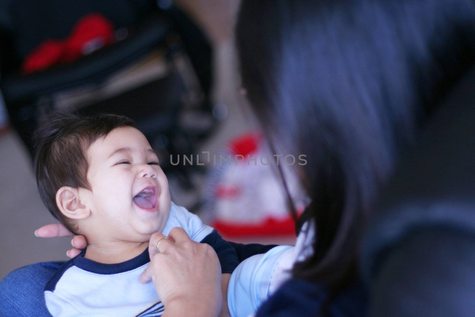 Mother tickling her baby