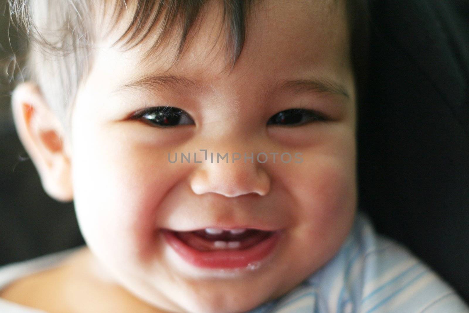 Baby boy with charming smile by jarenwicklund