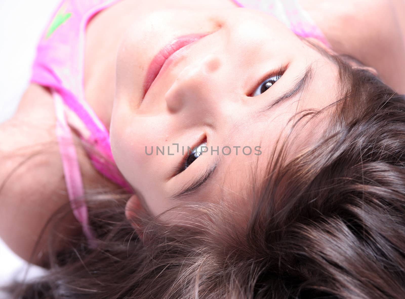 Girl looking upside down at camera, part Scandinavian part Thai background