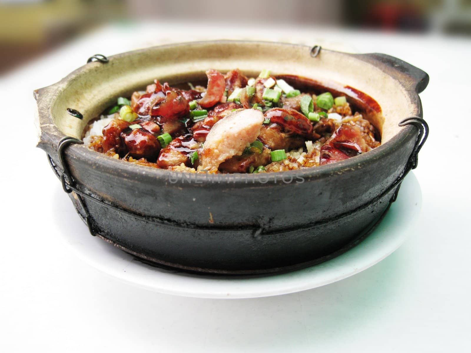 a bowl of clay pot chicken rice, asian style food