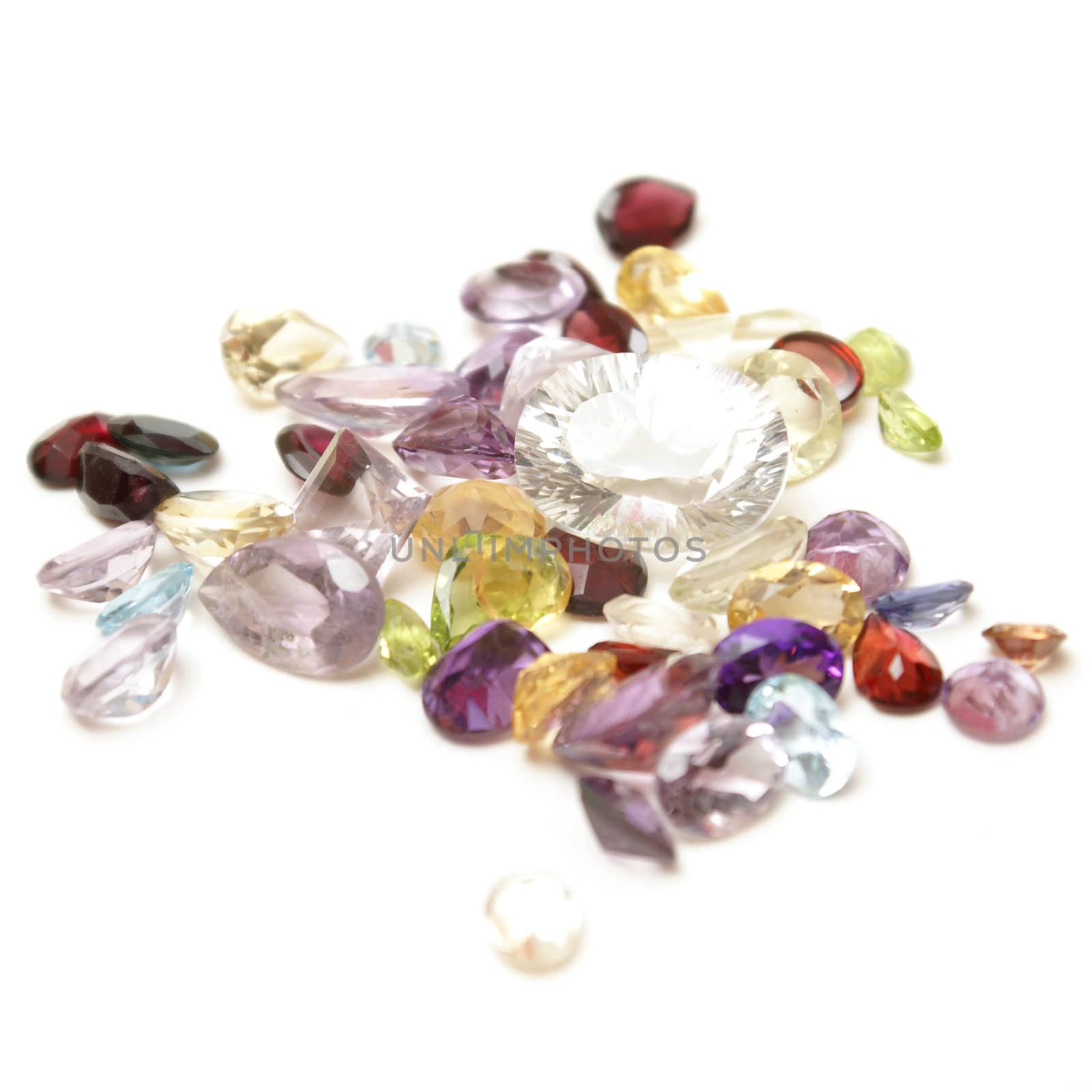 A handfull of mixed genuine gemstones isolated on white.