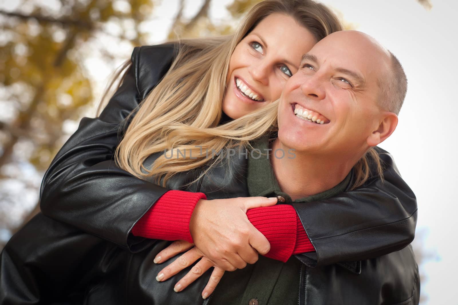 Happy, Attractive Couple in Park with Leather Jackets.