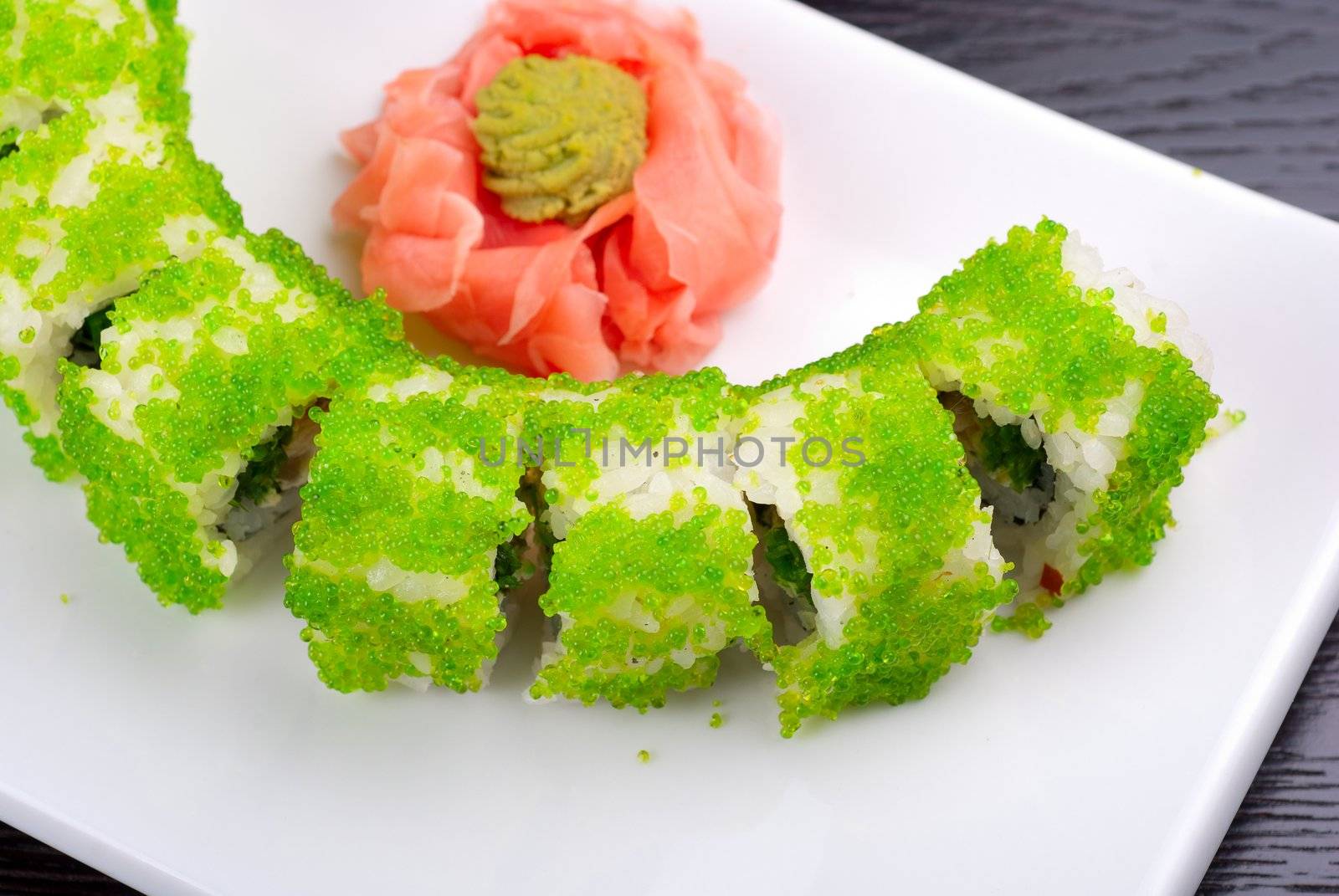 Sushi rolls made of salmon, avocado, flying fish roe - tobiko caviar and philadelphia cheese