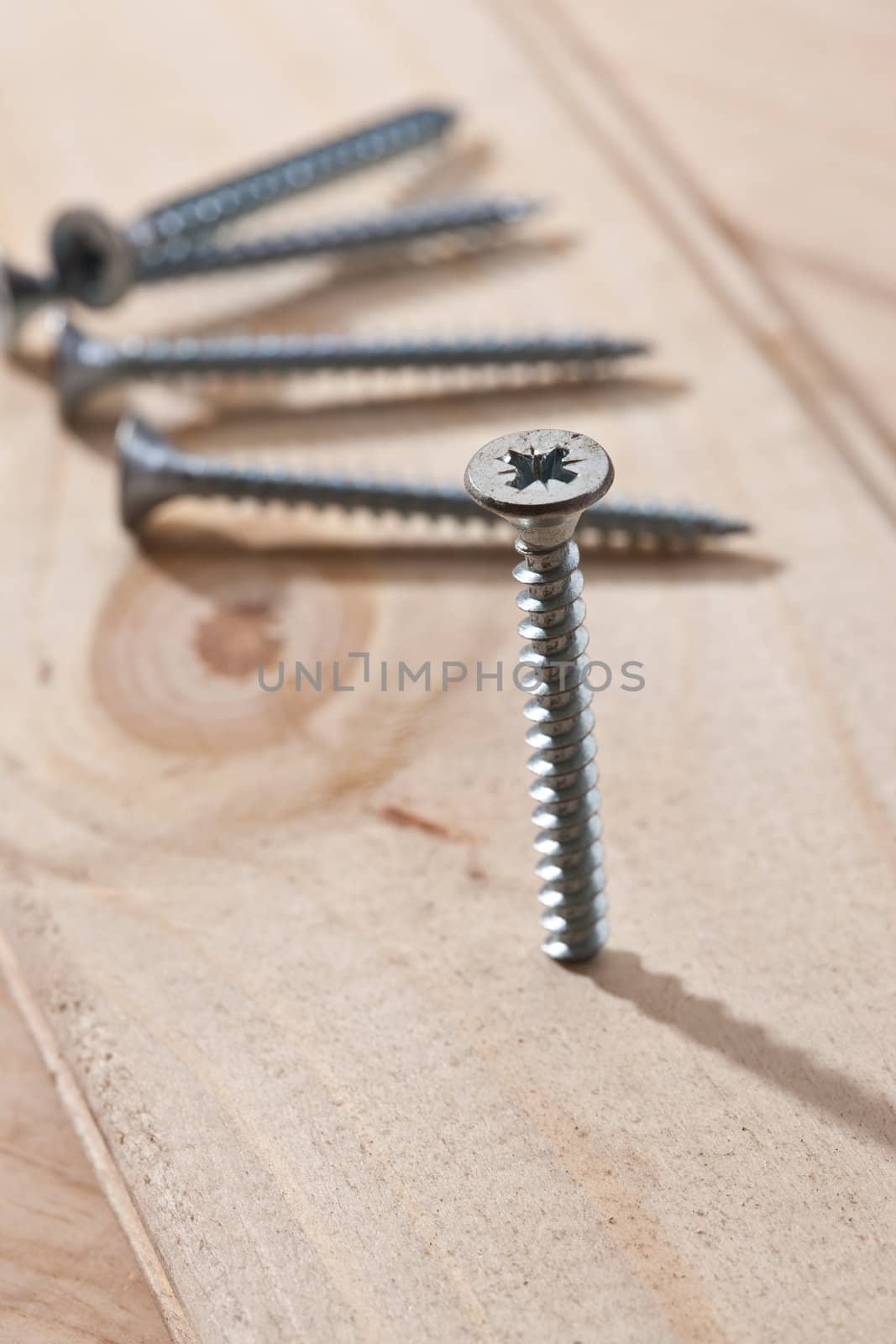 tools series: long screws on wooden table