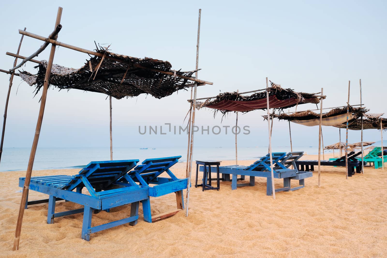 Exotic parasols and deck-chairs on tropical coast