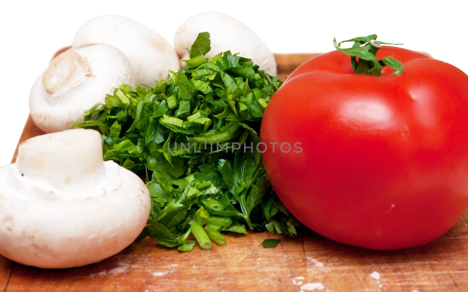 Some ingredients for pizza: parsley, mushrooms, tomatoes.