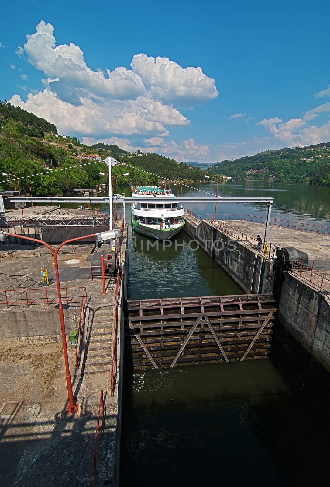 A tourist boat crossing the Carrapatelo Dam, Douro region, Portugal.