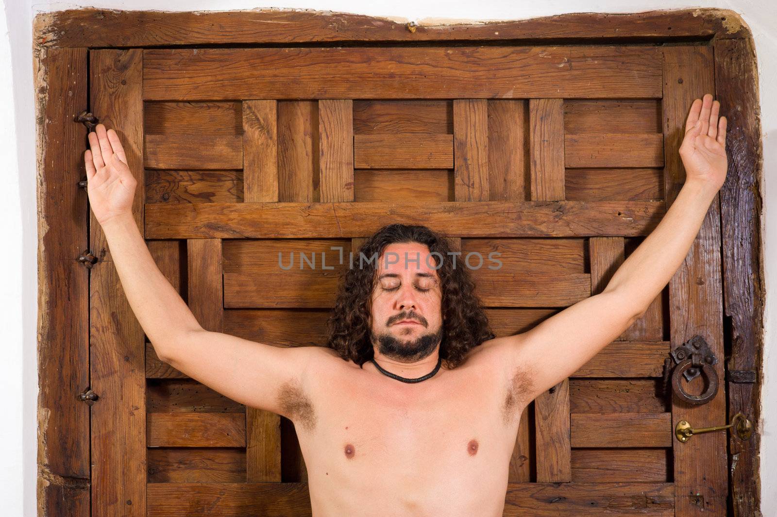 Long haired guy in contemplative attitude indoors