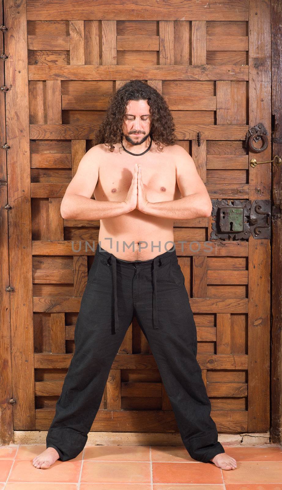 Long haired guy in contemplative attitude indoors