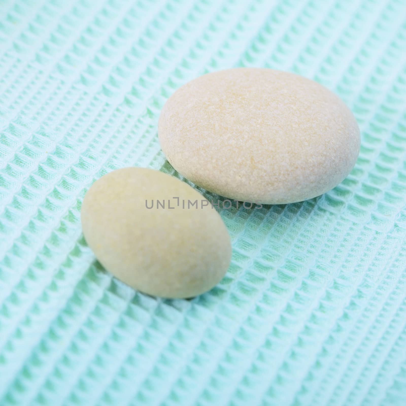 Two small round stone on towel by pzaxe