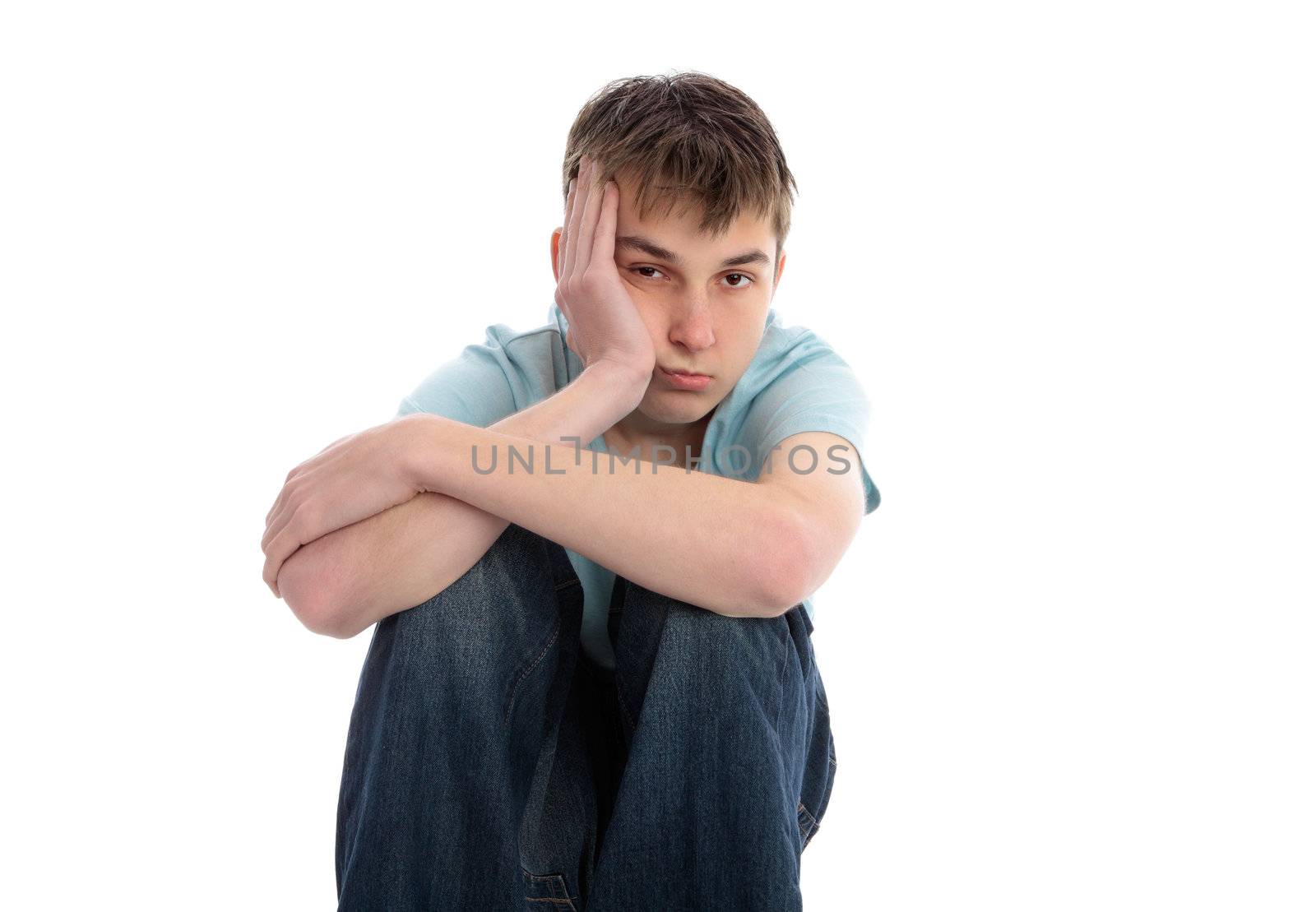 A sad, lethargic, lonely, depressed male sitting with head in one hand.