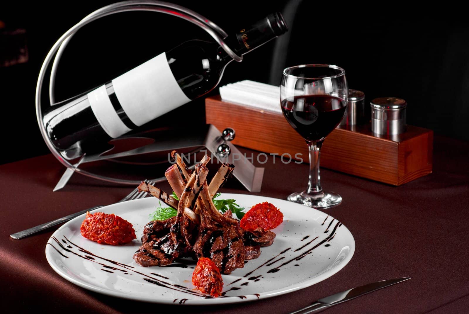 Roasted lamb chops with vegetables on decorated table