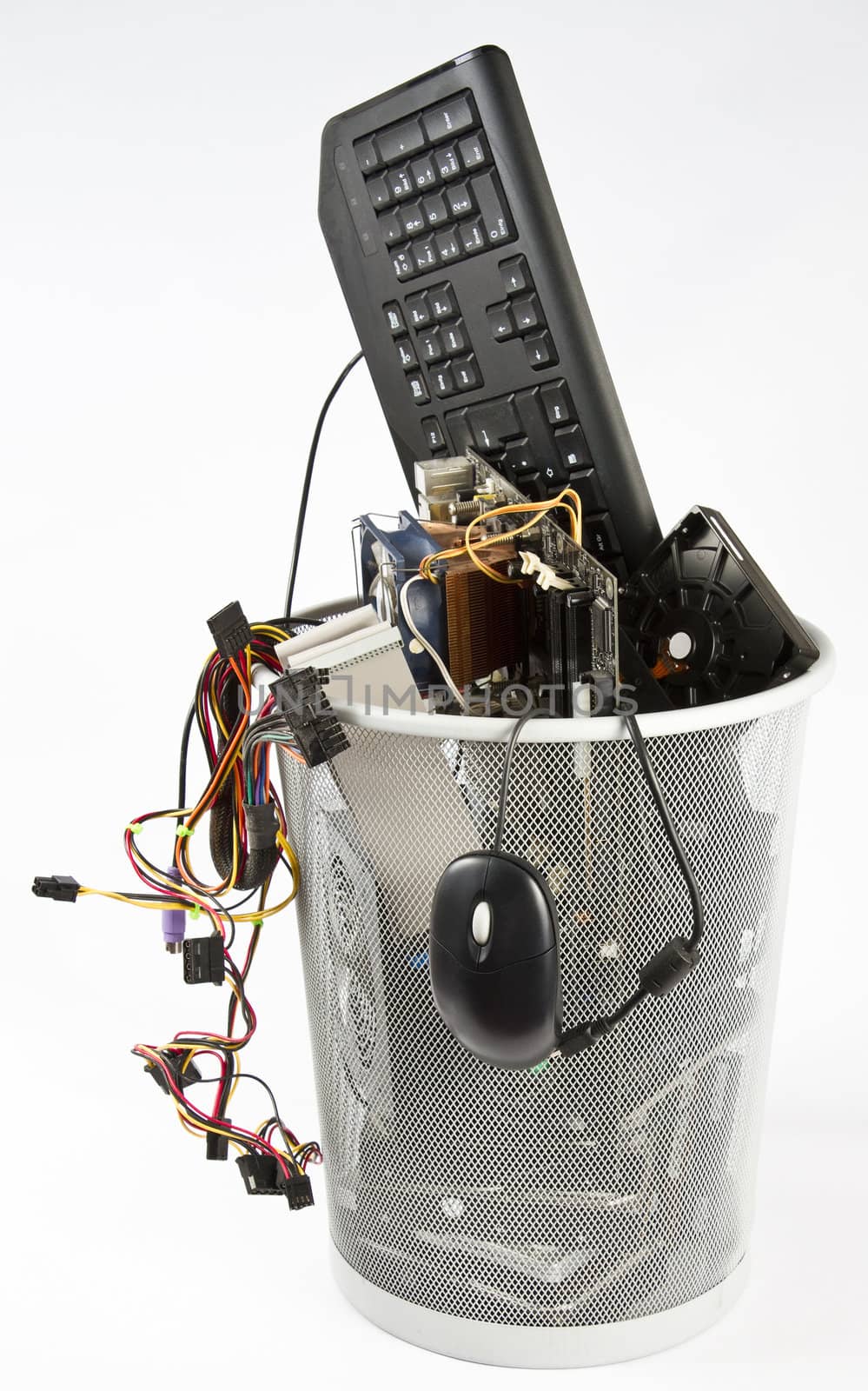 computer parts in trash can. grey background