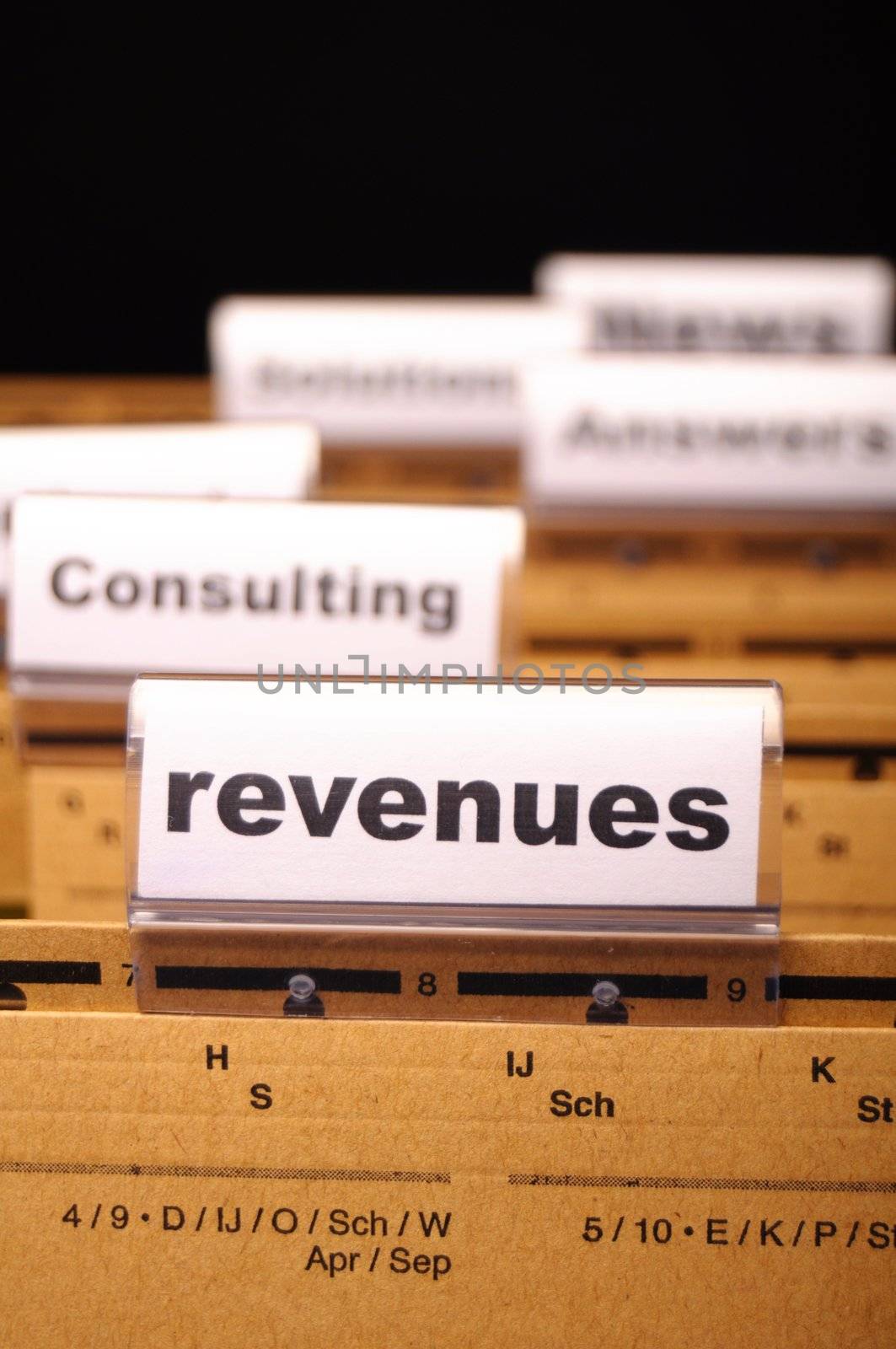 revenue or revenues word on business office folder showing financial success