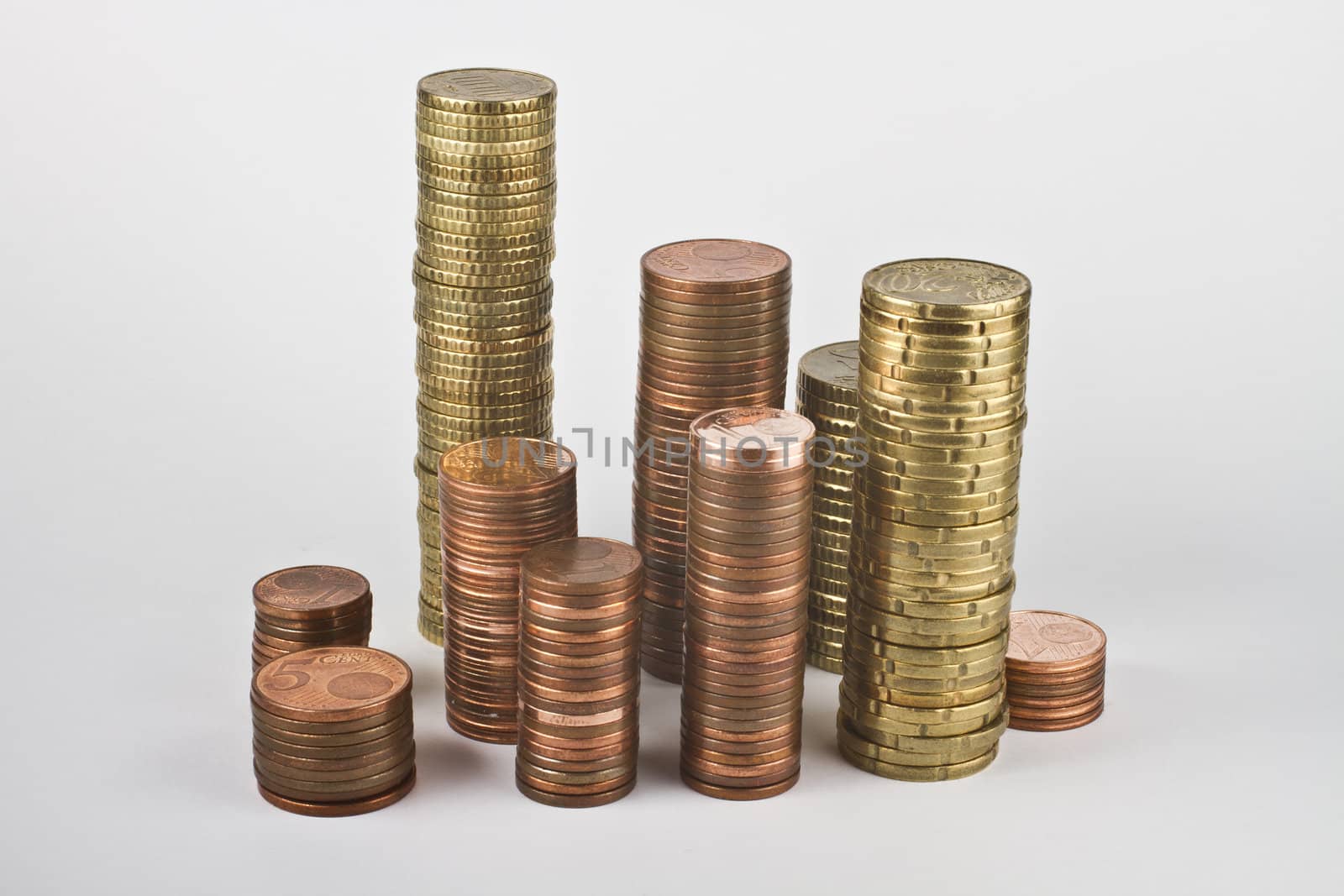 stacks of euro coins in grey background