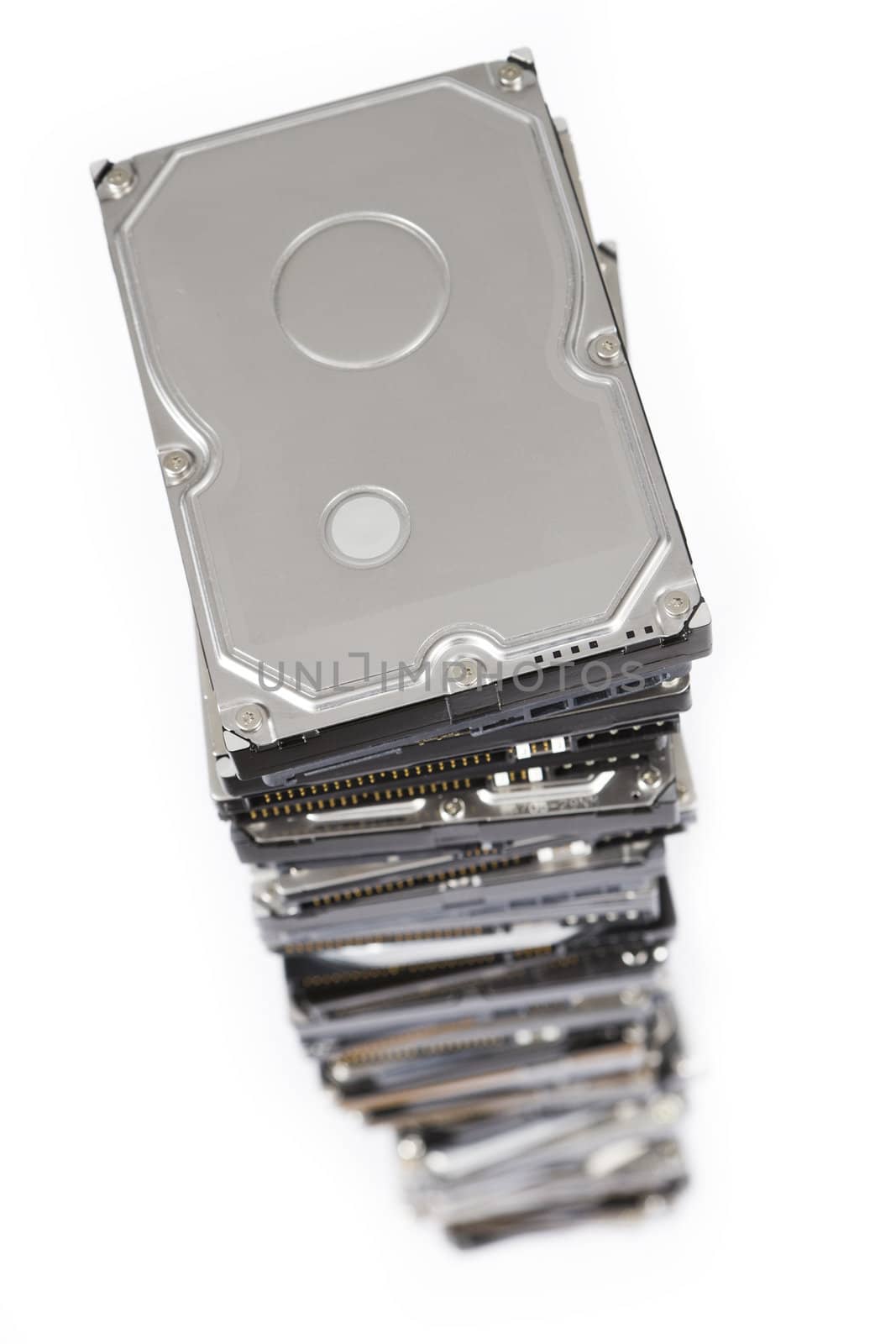 stack of hard drives on white background. Top view with selective focus.