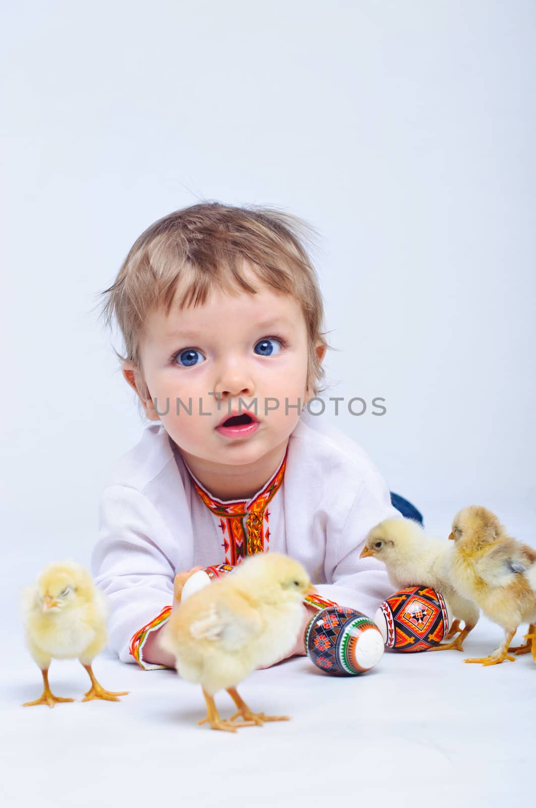 Cute little boy in embroidered with Easter eggs and easter chicks