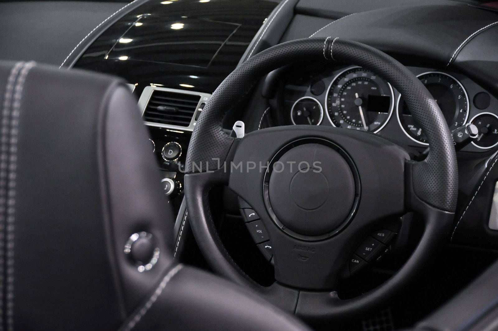 Luxury coupe dashboard, black leather and wood