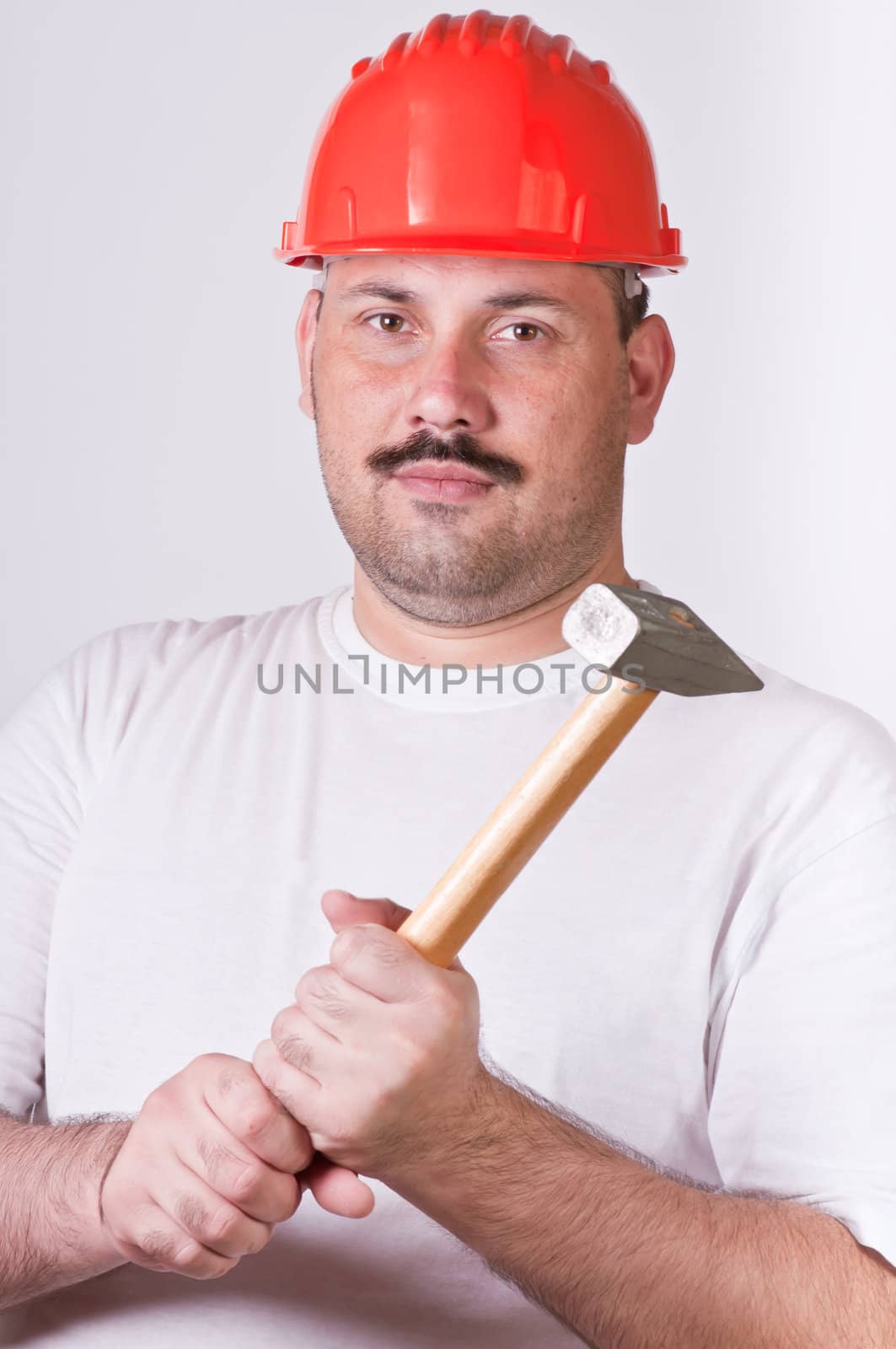 Handsome worker with adjustable wrench. Isolated over white background